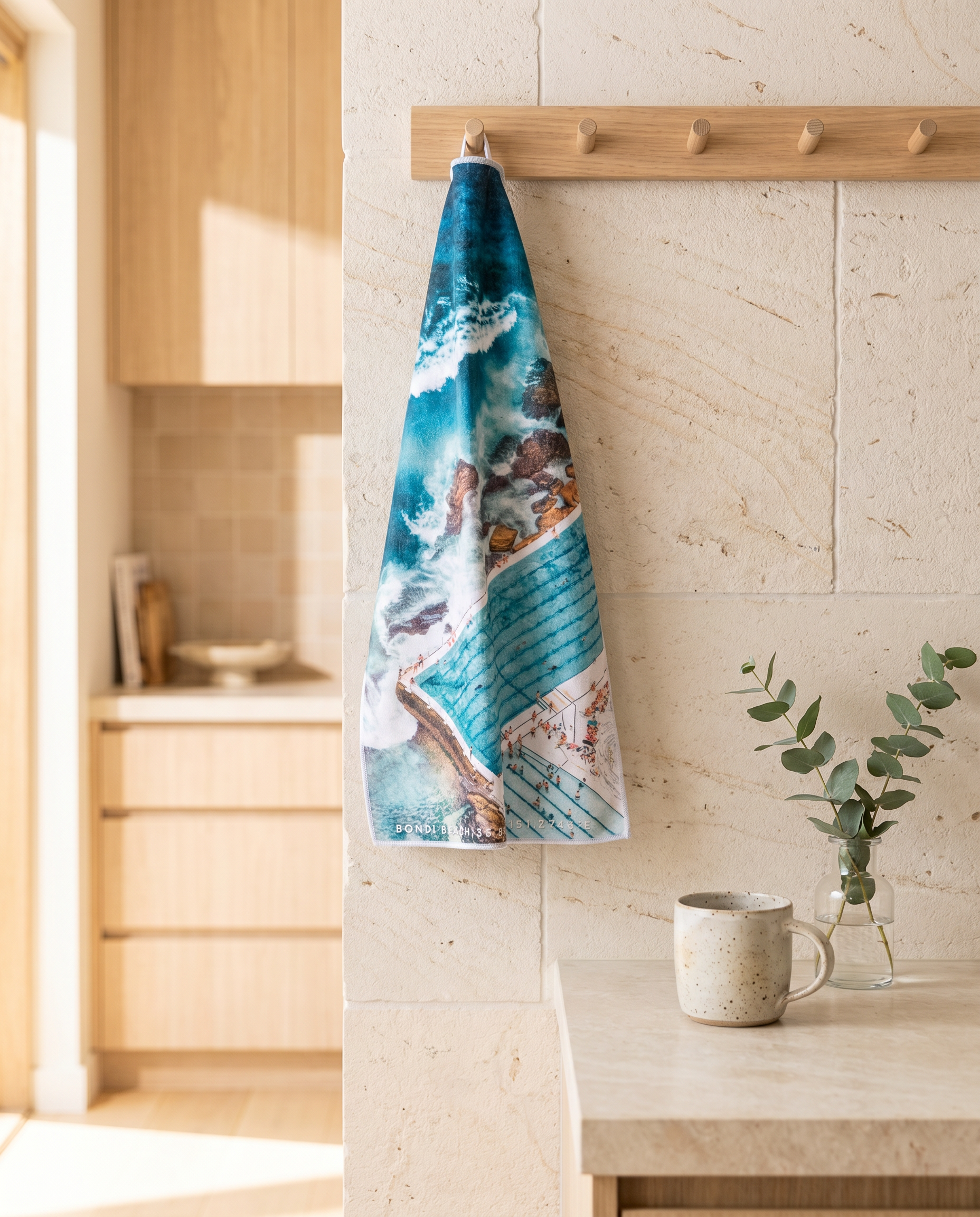 Icebergs Summer Australian tea towel hanging in a coastal kitchen
