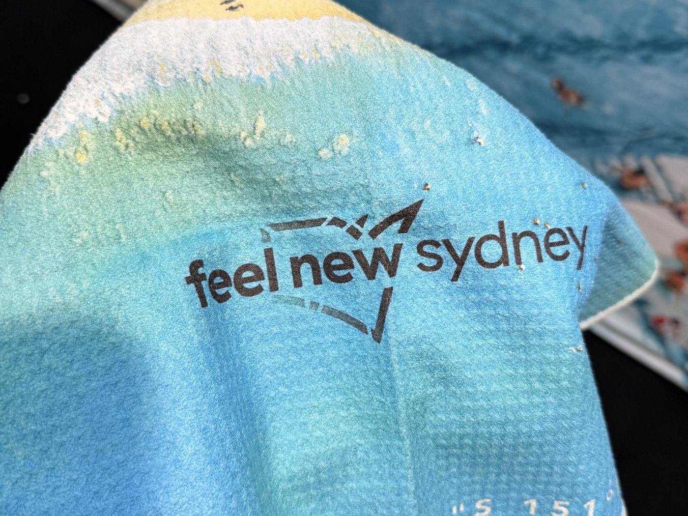 Custom printed Feel New in Sydney beach towel by Destination Label